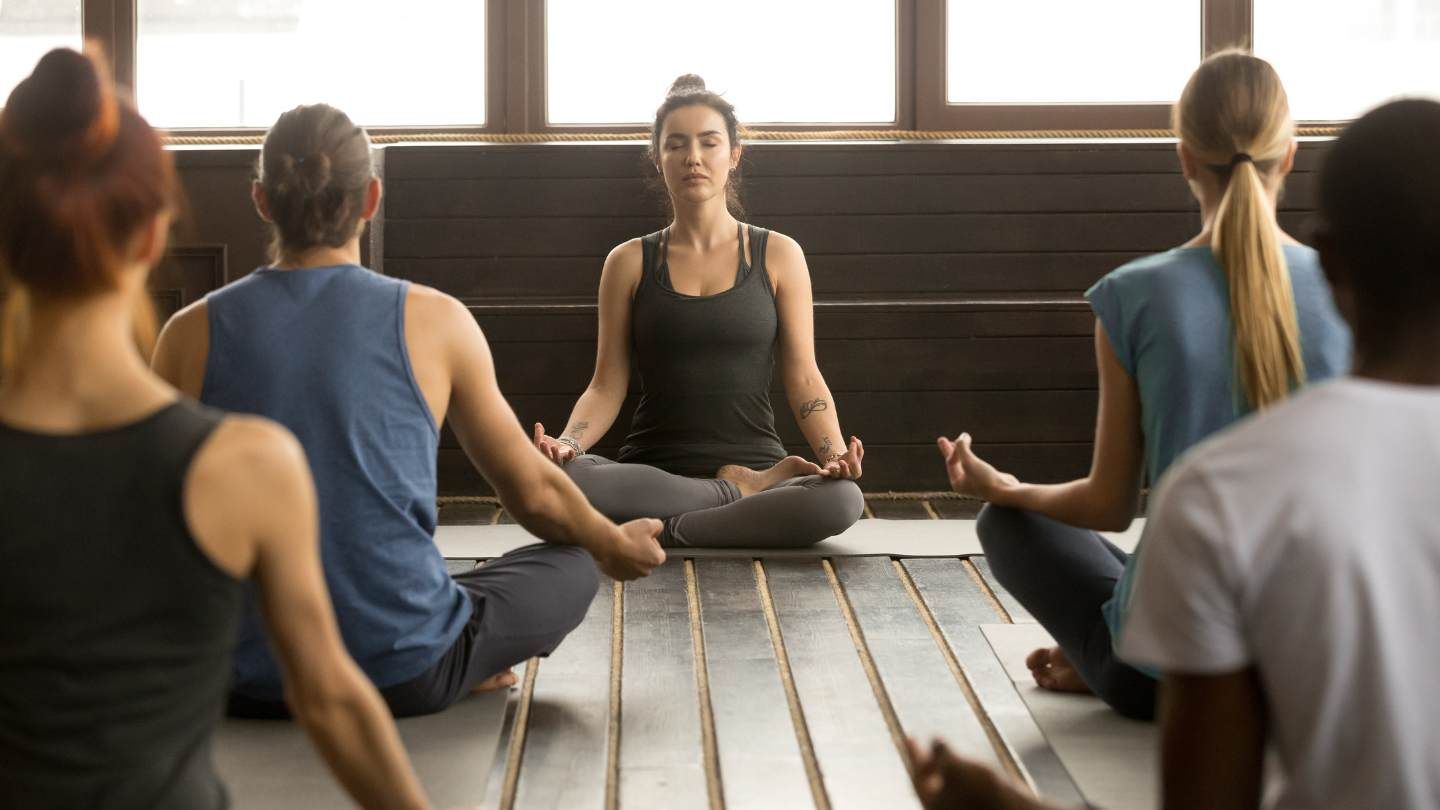 People engaging in yoga therapy following xanax addiction treatment to prevent relapse.