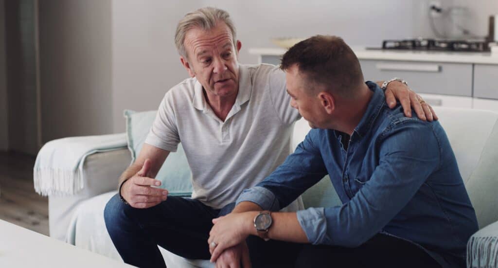 man talks to his adult son about going to rehab