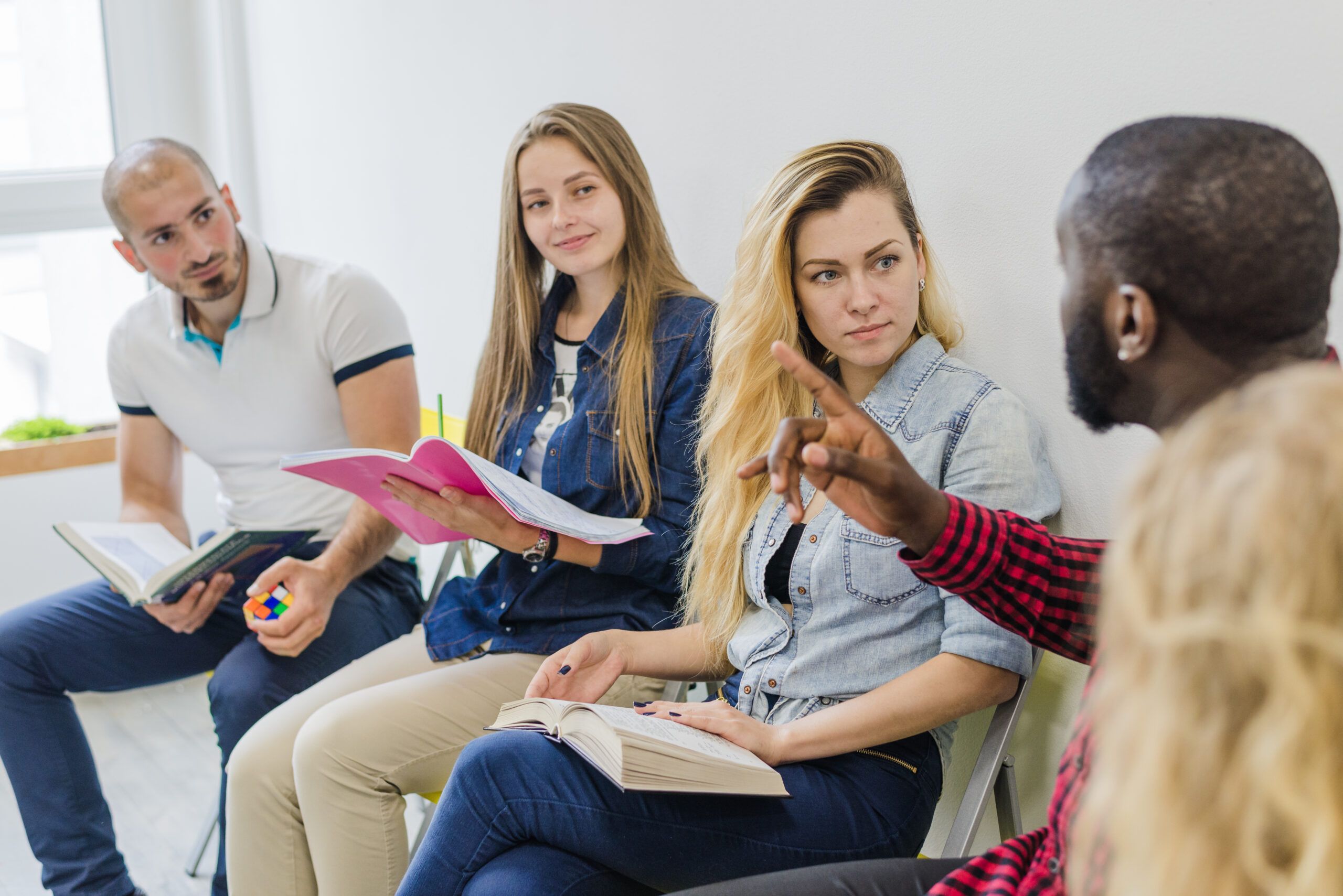 An informal therapy session in Shelbyville, Kentucky Drug and Alcohol Rehab Resources. People sit on colorful bean bags, engaging in a relaxed group discussion about addiction recovery, fostering an atmosphere of support and openness.