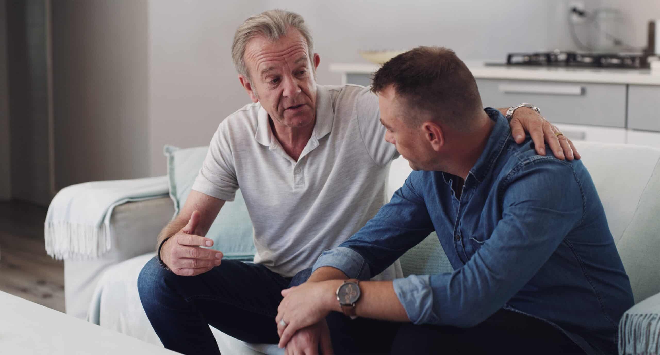 man talks to his adult son about going to rehab