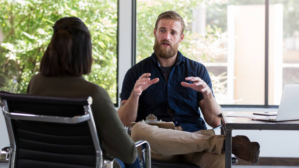Interventionist helping a client with addiction recovery questions and answers.