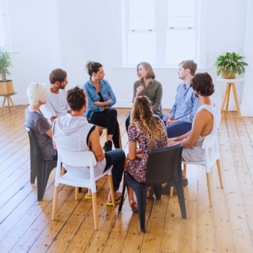 An open room with a group of individuals in a circle, attentively listening to each other at a Pikeville, Kentucky Drug and Alcohol Rehab Resources session. This setting fosters understanding and growth for participants seeking recovery.
