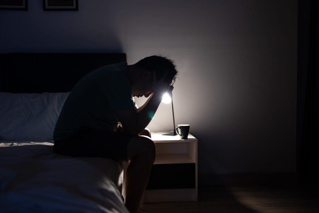 man can't sleep due to his OCD symptom of ruminating thoughts