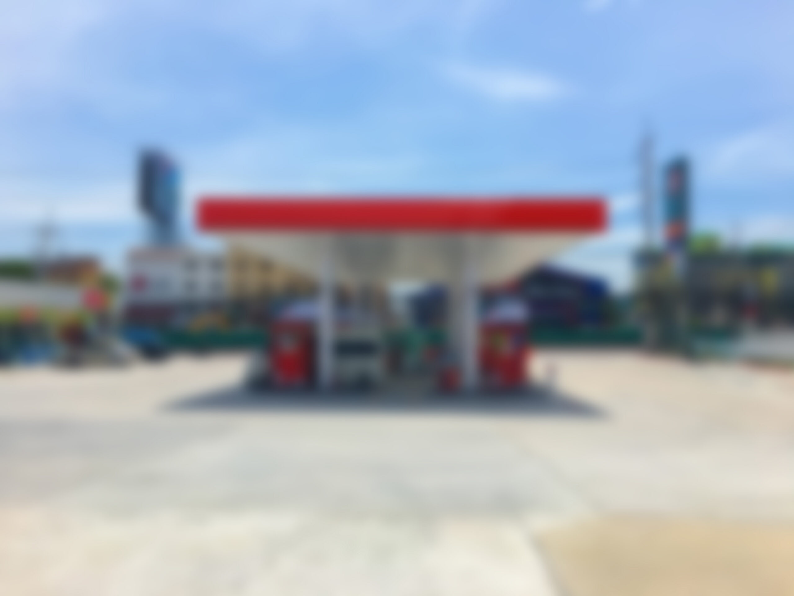 Blurred gas station and convenience store illustrating the retail availability of emerging psychoactive products