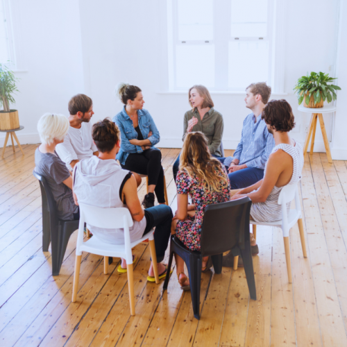 An open room with a group of individuals in a circle, attentively listening to each other at a Pikeville, Kentucky Drug and Alcohol Rehab Resources session. This setting fosters understanding and growth for participants seeking recovery.